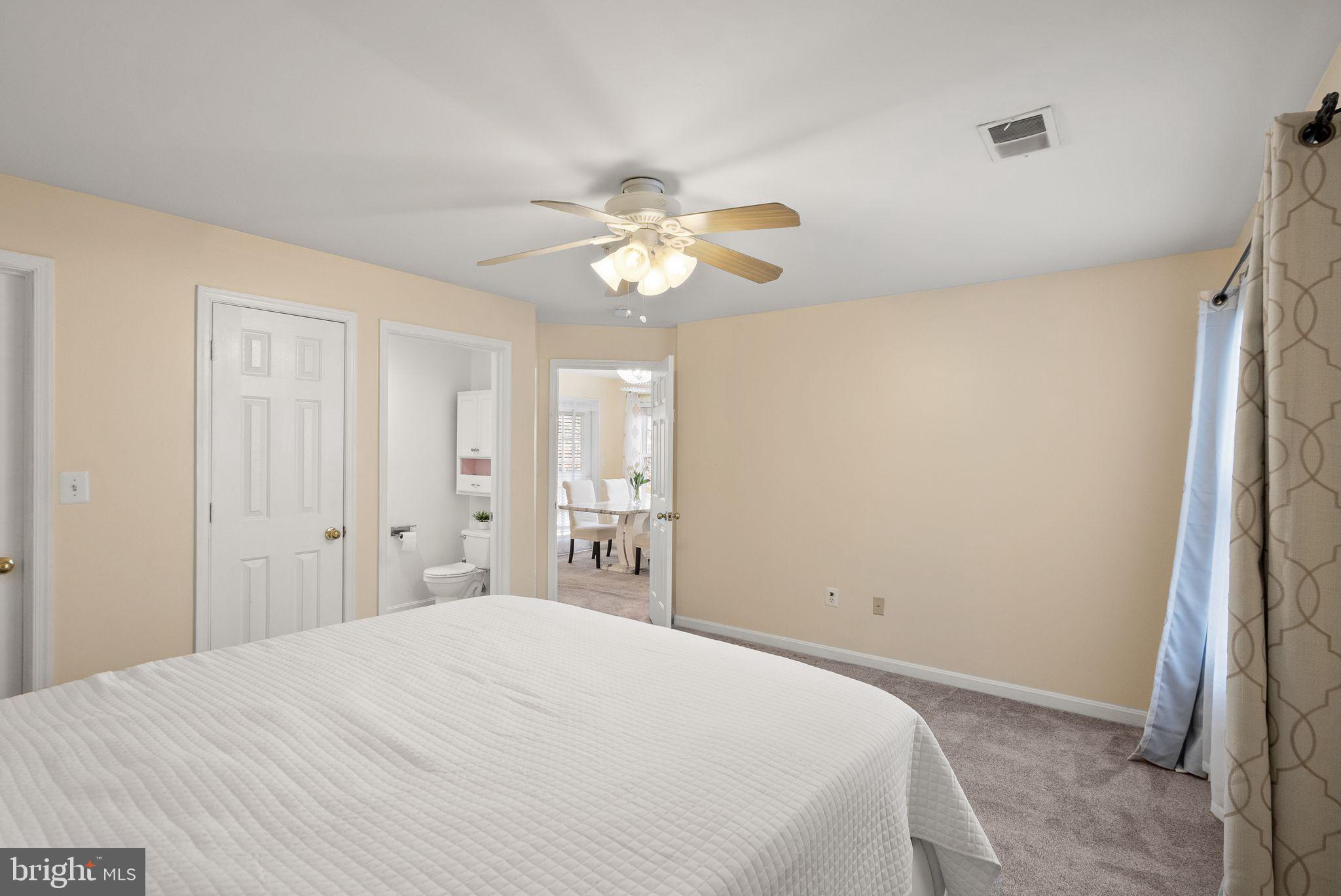 521 Constellation Square Southeast, Unit E Leesburg, VA 20175 - Photo 15 of 27 a bedroom with a bed and a chandelier