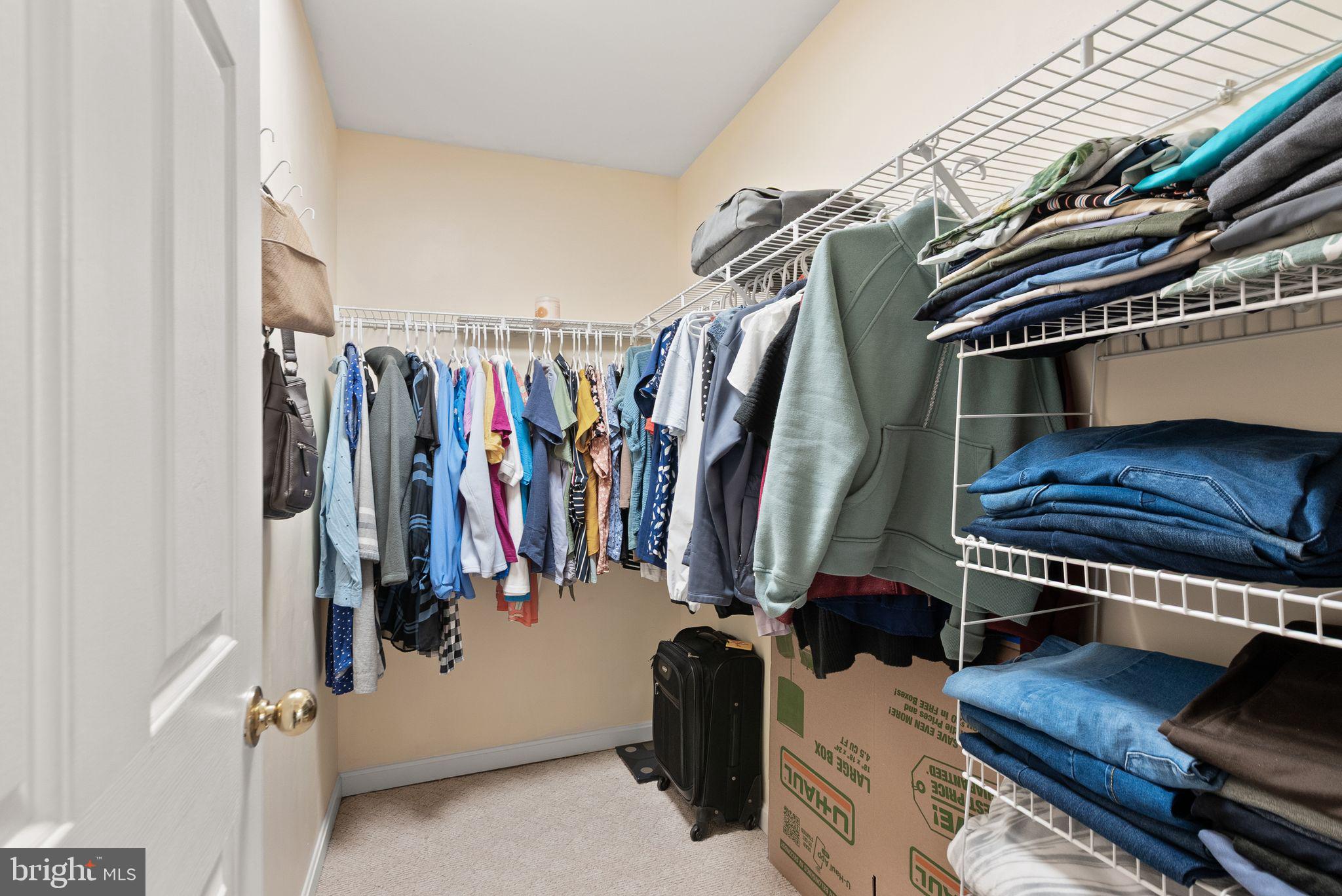 521 Constellation Square Southeast, Unit E Leesburg, VA 20175 - Photo 18 of 27 a view of walk in closet with clothes and shoes