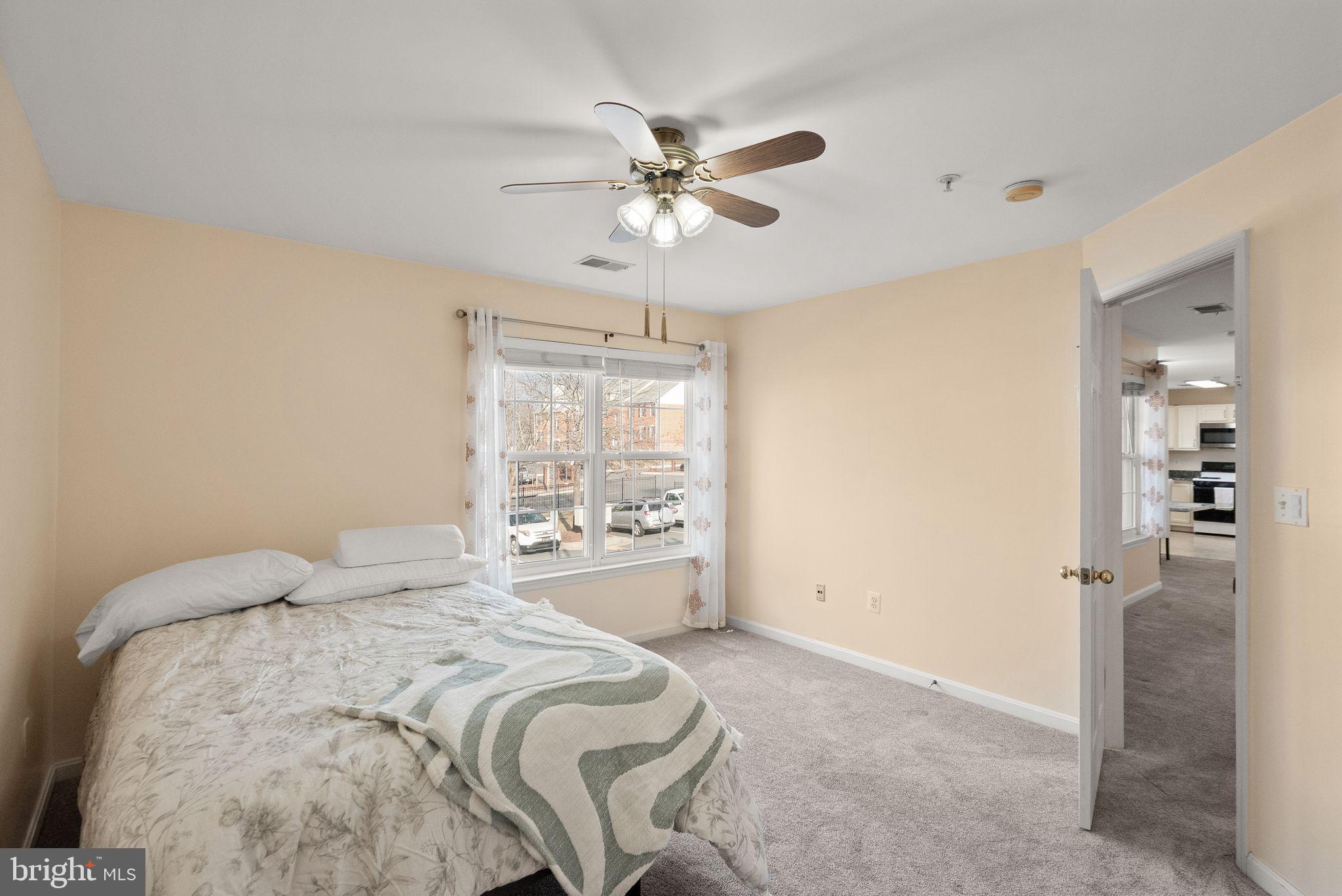 521 Constellation Square Southeast, Unit E Leesburg, VA 20175 - Photo 19 of 27 a bedroom with a bed and a chandelier