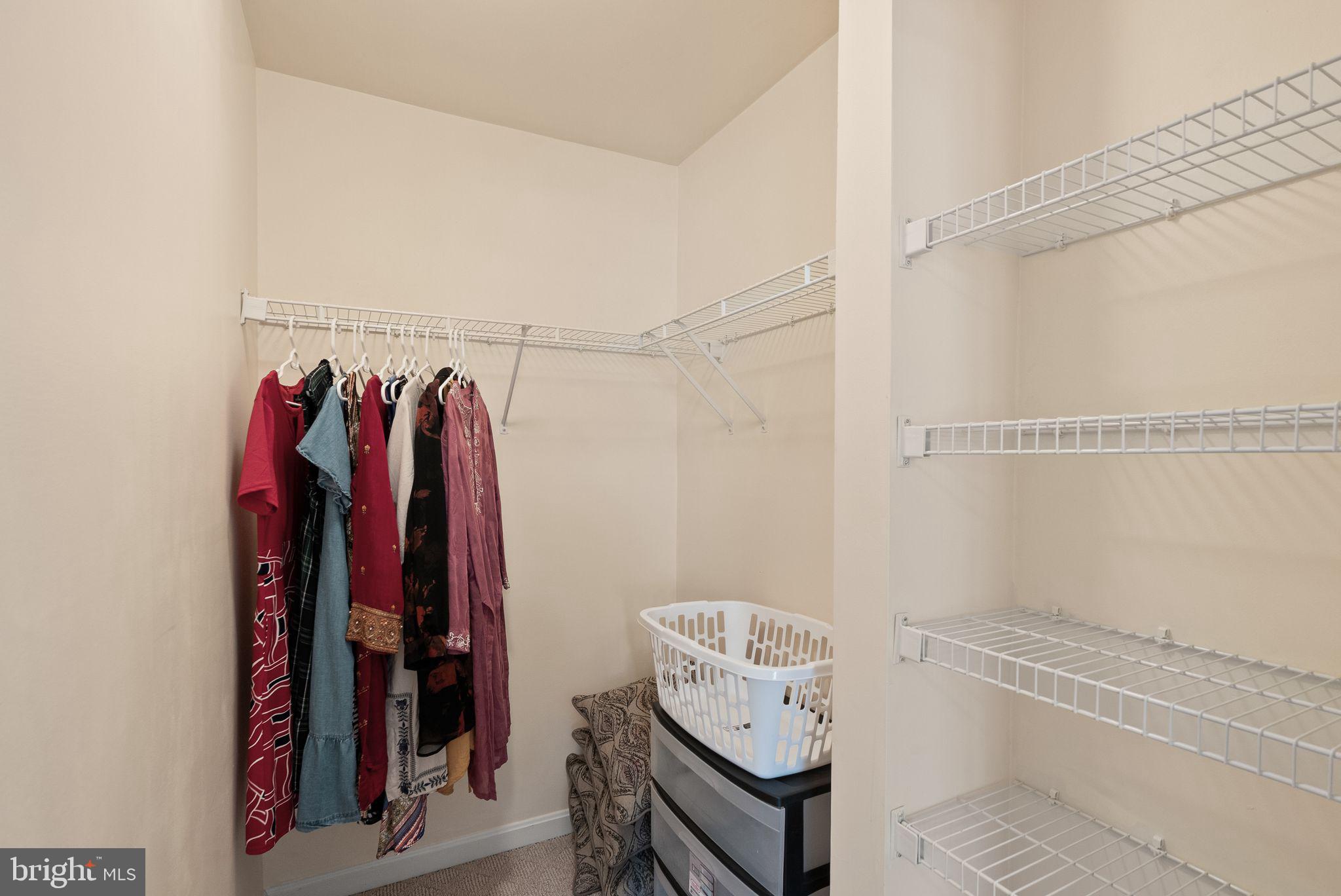 521 Constellation Square Southeast, Unit E Leesburg, VA 20175 - Photo 20 of 27 a view of walk in closet with clothes and shoes