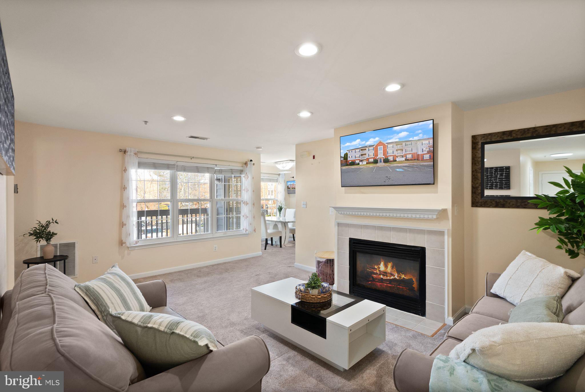 521 Constellation Square Southeast, Unit E Leesburg, VA 20175 - Photo 2 of 27 a living room with furniture and a fireplace