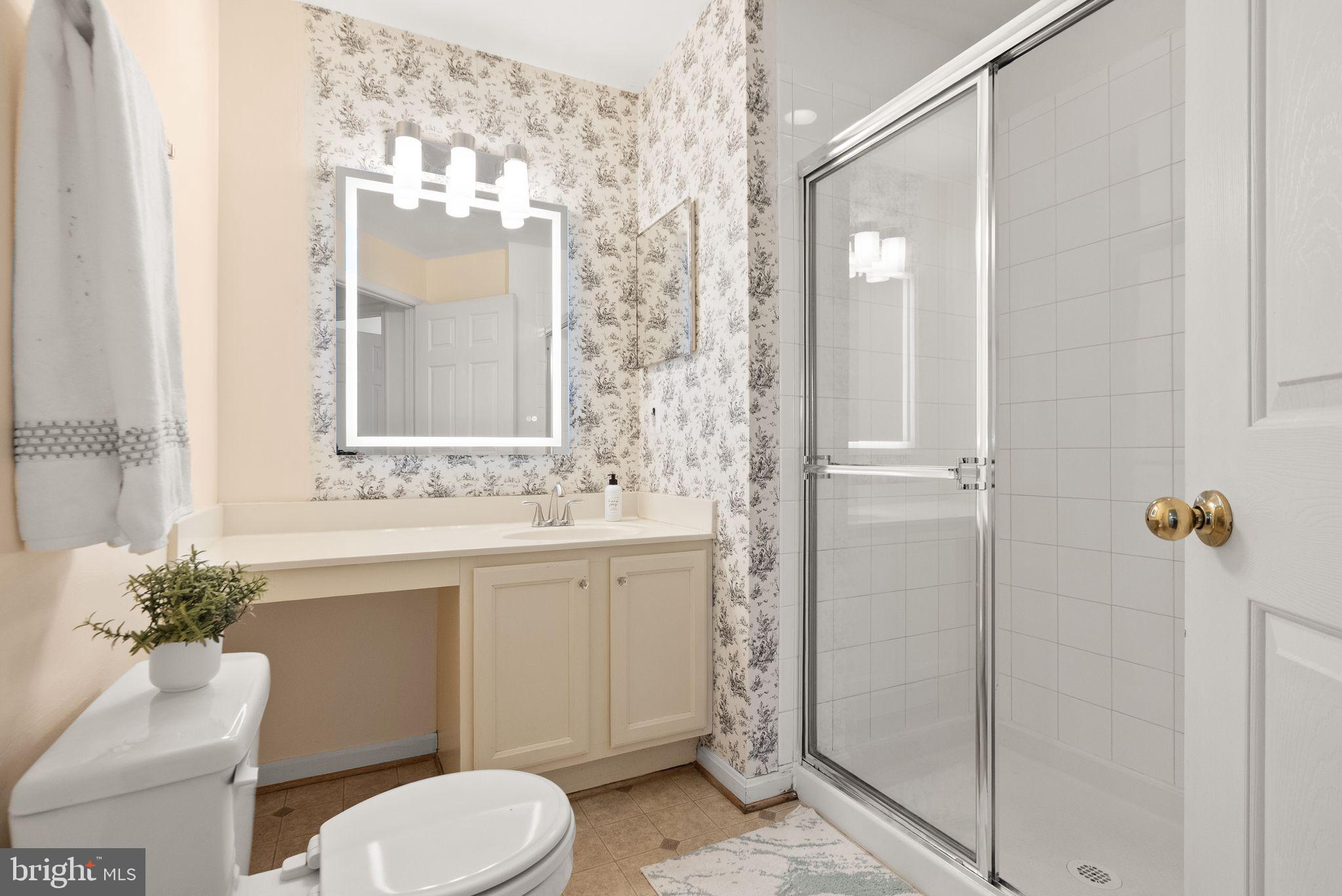 521 Constellation Square Southeast, Unit E Leesburg, VA 20175 - Photo 21 of 27 a bathroom with a sink toilet and shower