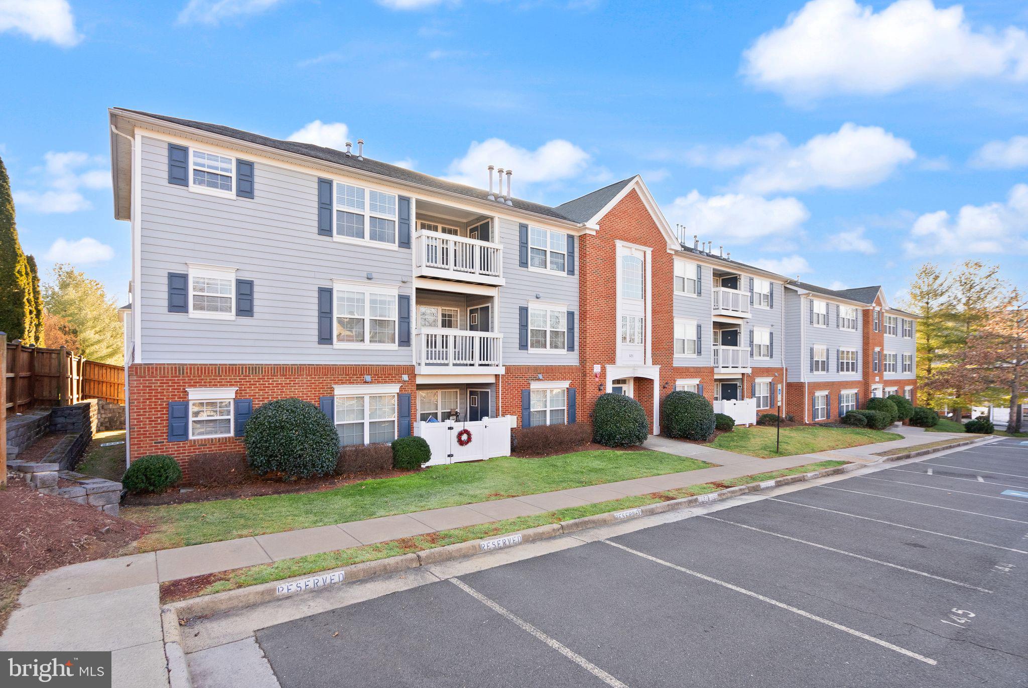 521 Constellation Square Southeast, Unit E Leesburg, VA 20175 - Photo 22 of 27 a front view of a building with a garden and plants