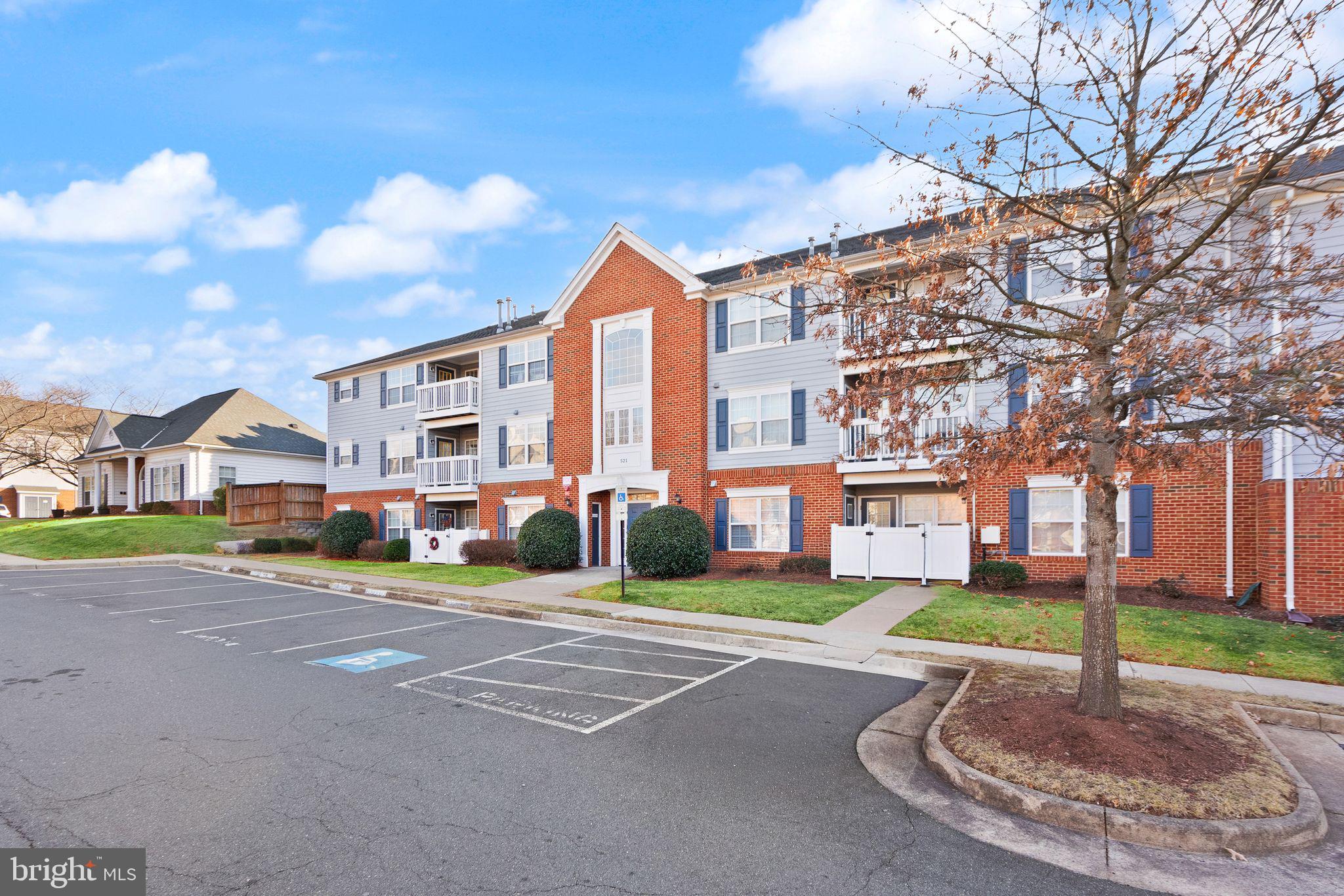 521 Constellation Square Southeast, Unit E Leesburg, VA 20175 - Photo 23 of 27 a front view of a building with a yard and trees