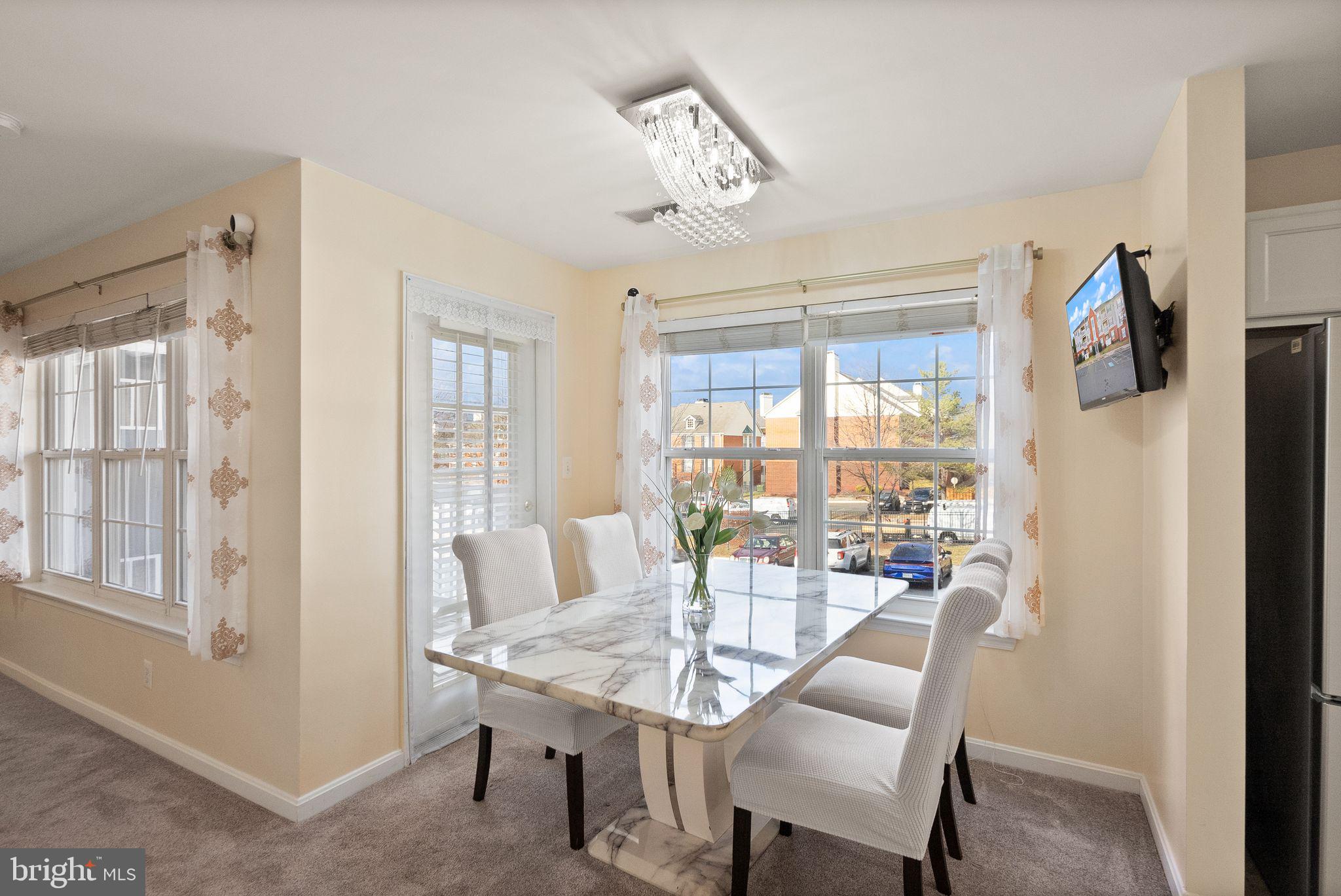 521 Constellation Square Southeast, Unit E Leesburg, VA 20175 - Photo 5 of 27 a view of a dining room with furniture window and outside view