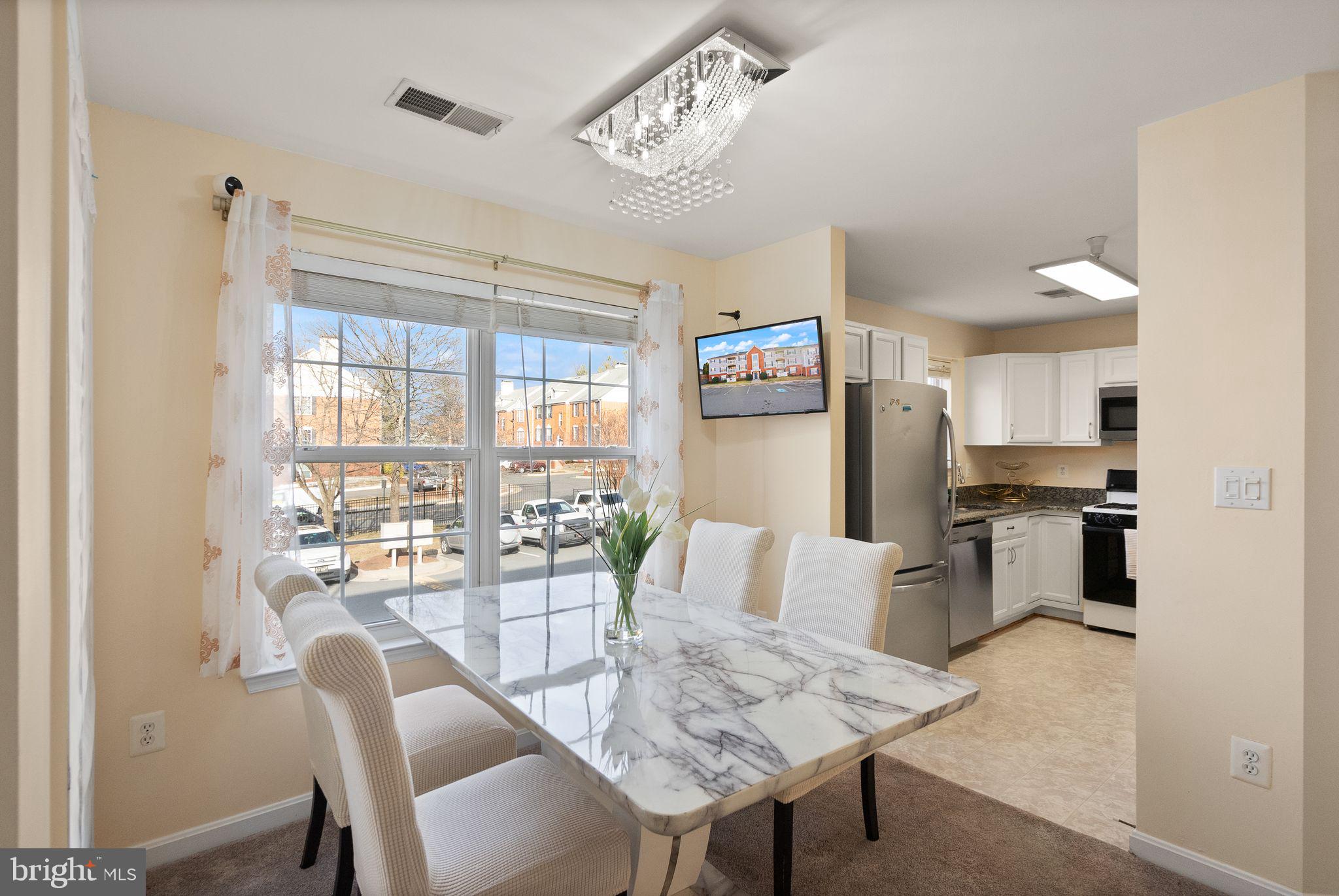 521 Constellation Square Southeast, Unit E Leesburg, VA 20175 - Photo 6 of 27 a view of a dining room with furniture window and outside view