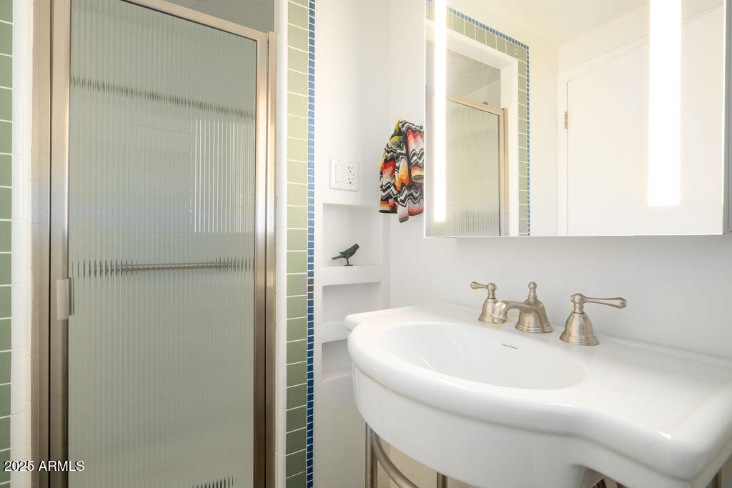2201 North Central Avenue, Unit 4E Phoenix, AZ 85004 - Photo 11 of 11 a bathroom with a sink and a mirror