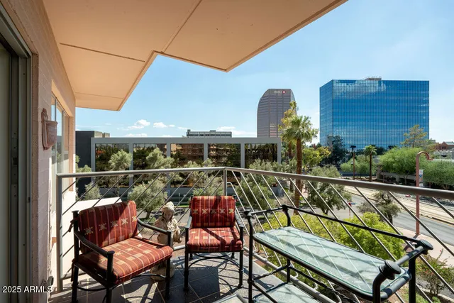 a view of a chairs and table on the balcony