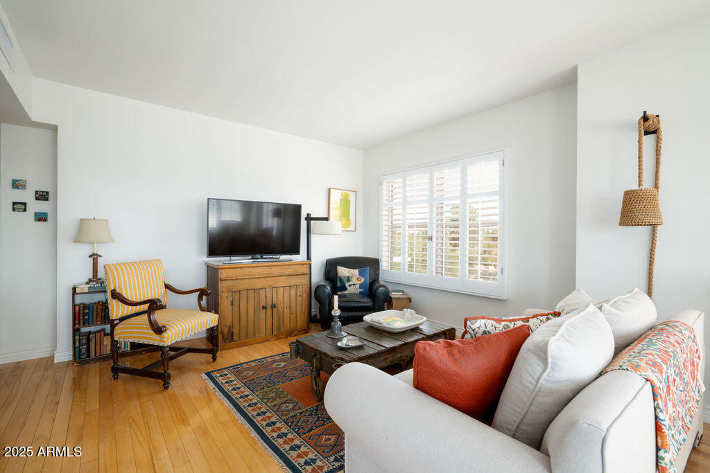 2201 North Central Avenue, Unit 4E Phoenix, AZ 85004 - Photo 5 of 11 a living room with furniture and a flat screen tv