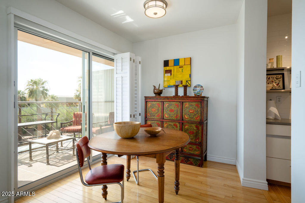 2201 North Central Avenue, Unit 4E Phoenix, AZ 85004 - Photo 6 of 11 a view of a dining room with furniture and wooden floor