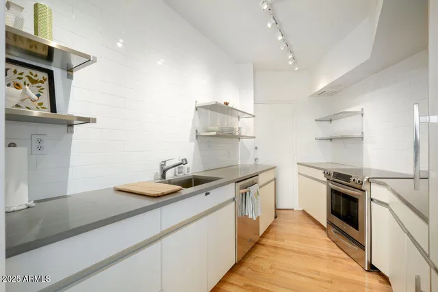 a kitchen with a sink stove and refrigerator