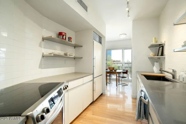 a kitchen with a sink and wooden cabinets