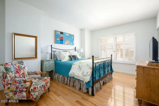a bedroom with furniture and a flat screen tv