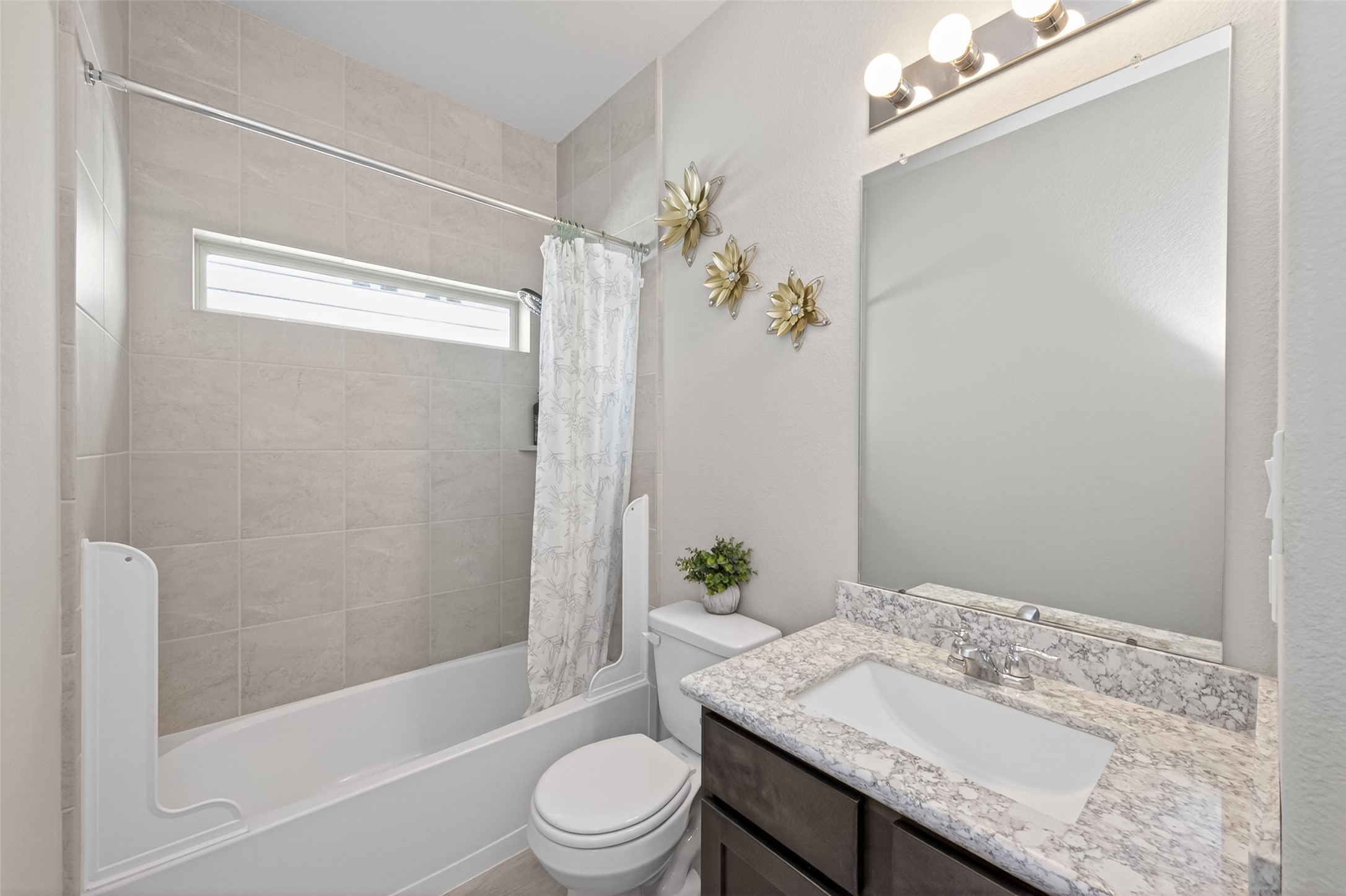 22409 Kinley Street New Caney, TX 77357 - Photo 38 of 46 a bathroom with a granite countertop sink a toilet and shower