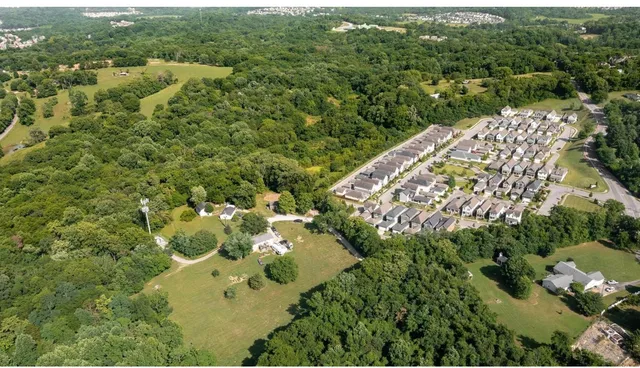 an aerial view of a house with a yard