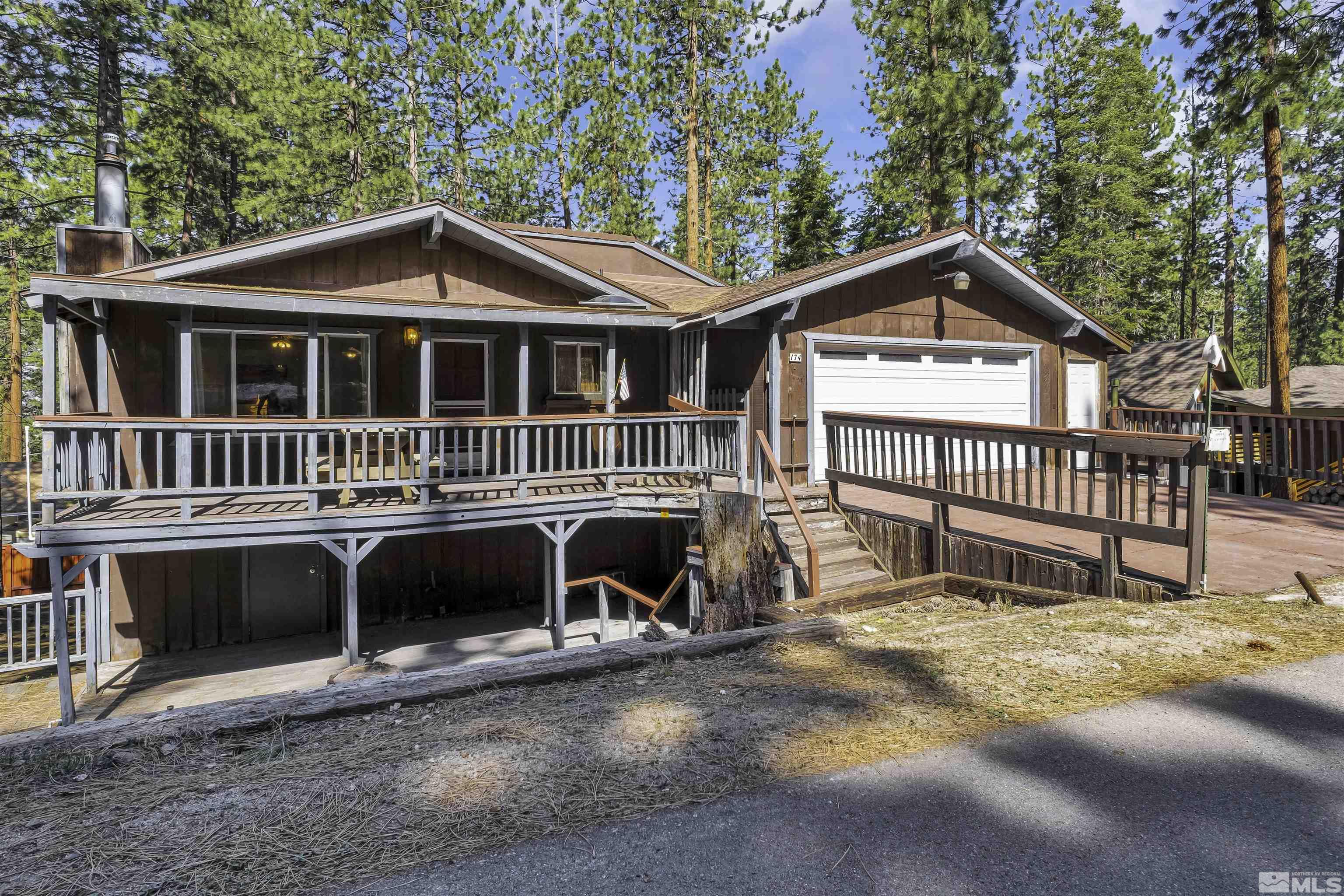 174 Juniper Drive Stateline, NV 89449 - Photo 1 of 32 a front view of a house with a yard table and chairs