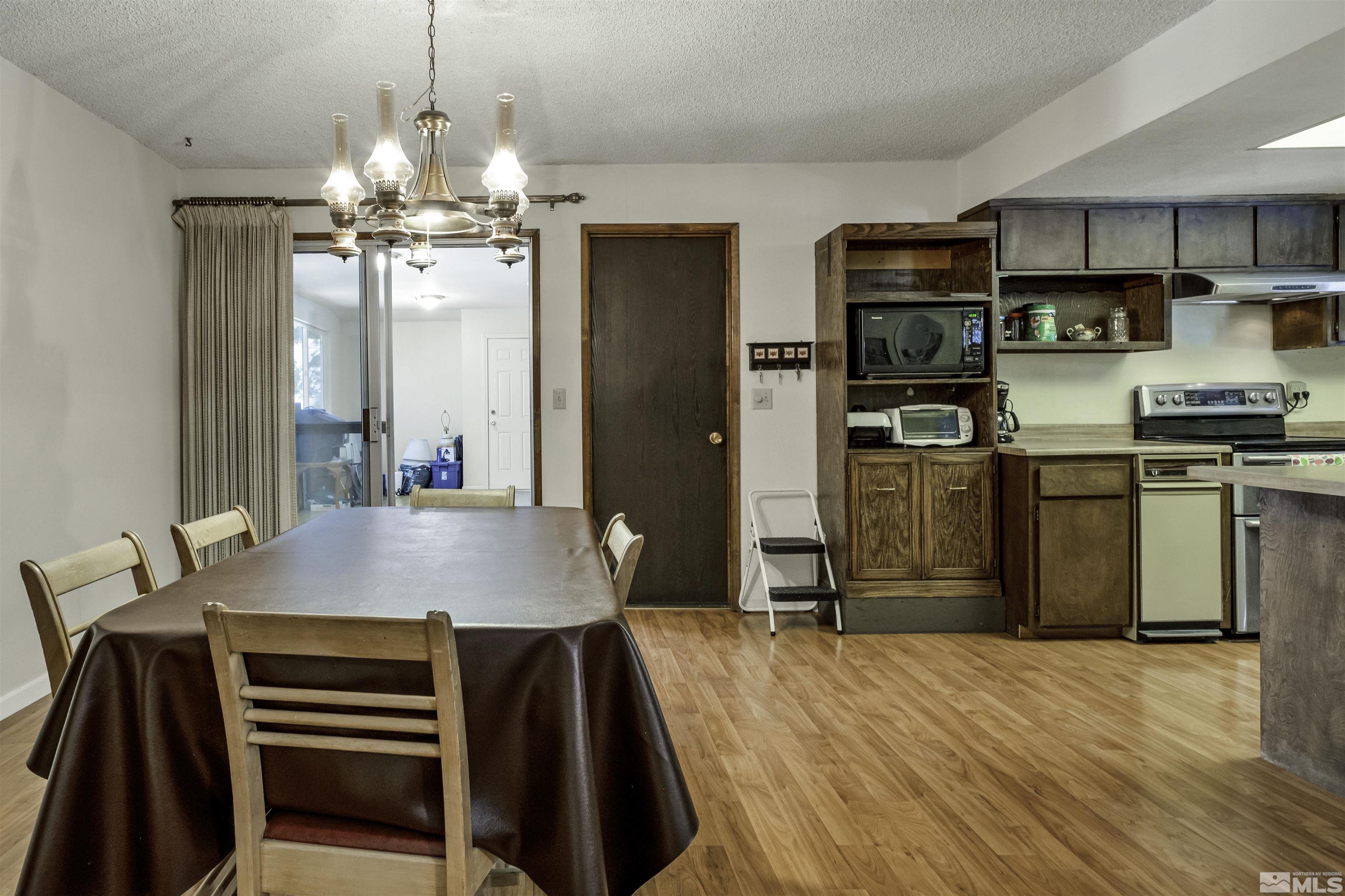 174 Juniper Drive Stateline, NV 89449 - Photo 12 of 32 a kitchen with kitchen island a sink appliances and cabinets