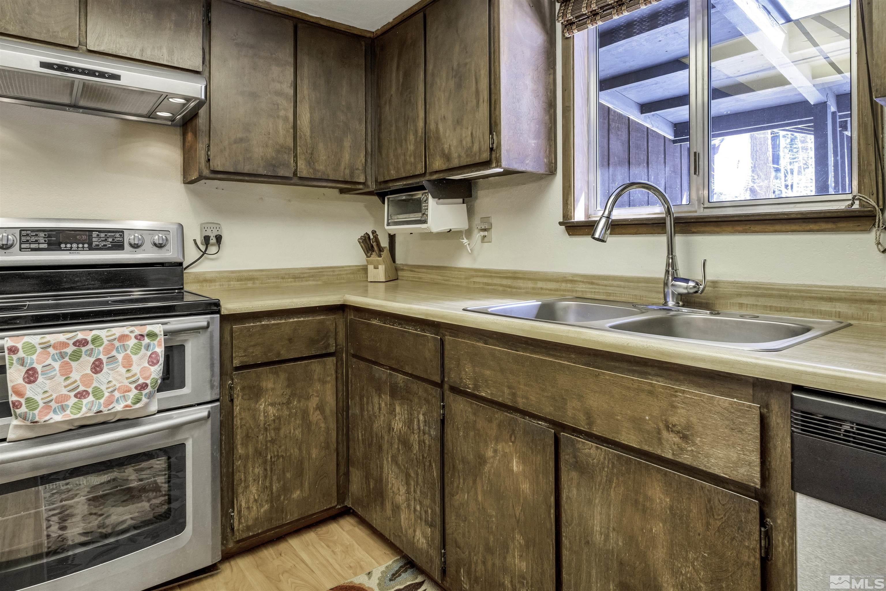 174 Juniper Drive Stateline, NV 89449 - Photo 13 of 32 a kitchen with appliances cabinets and a sink