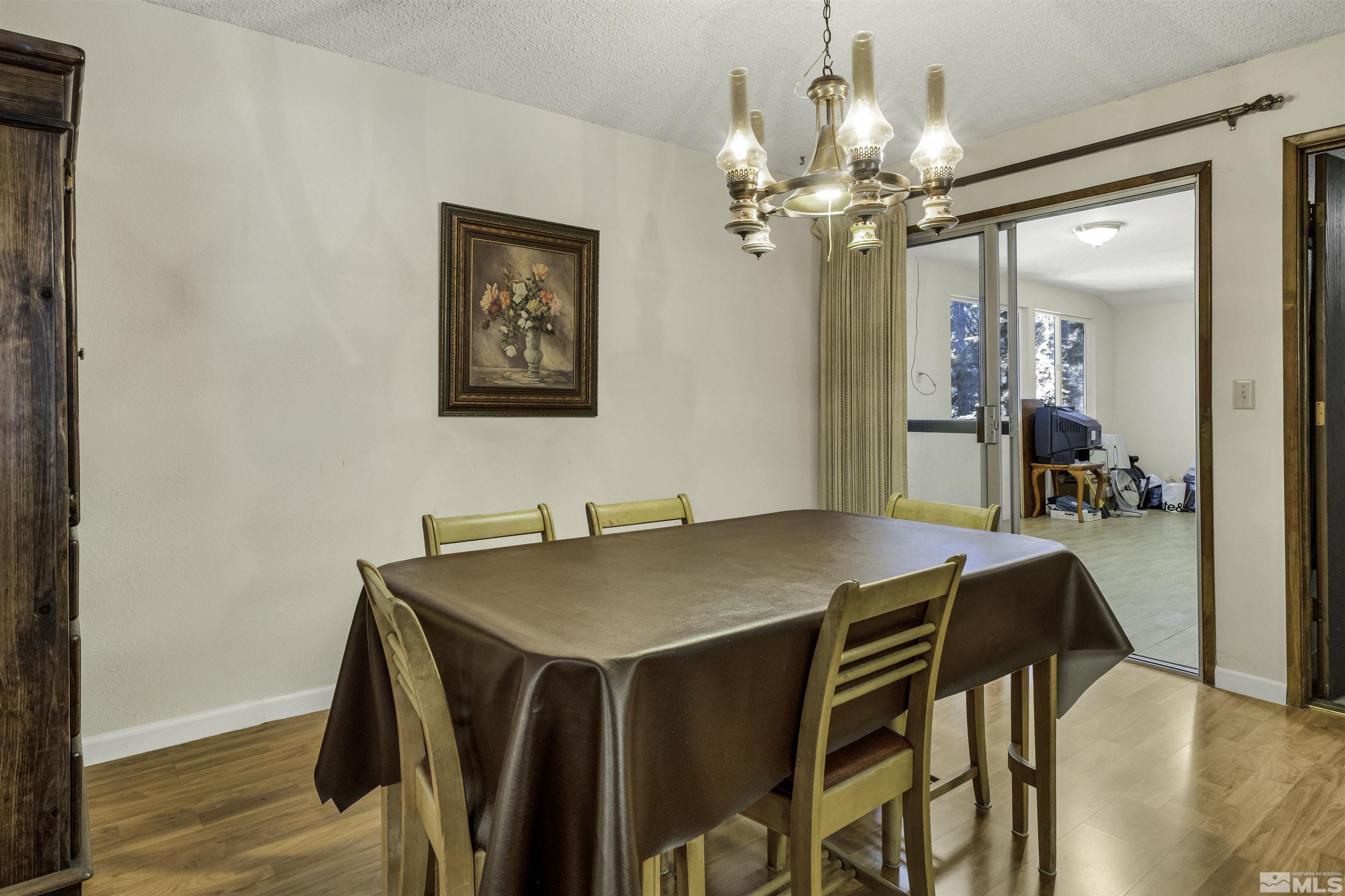 174 Juniper Drive Stateline, NV 89449 - Photo 15 of 32 a view of a dining room with furniture and wooden floor