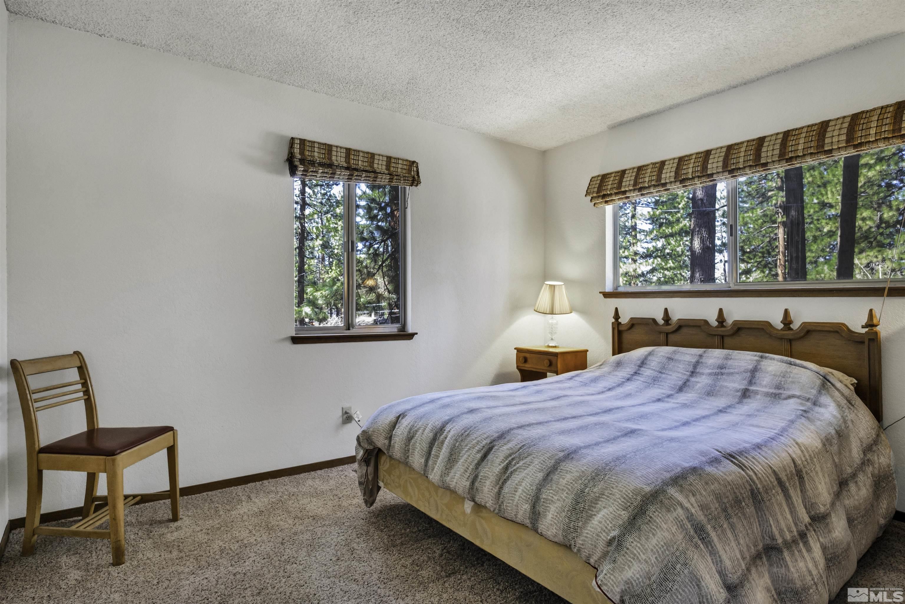 174 Juniper Drive Stateline, NV 89449 - Photo 19 of 32 a bed sitting in a bedroom next to a window