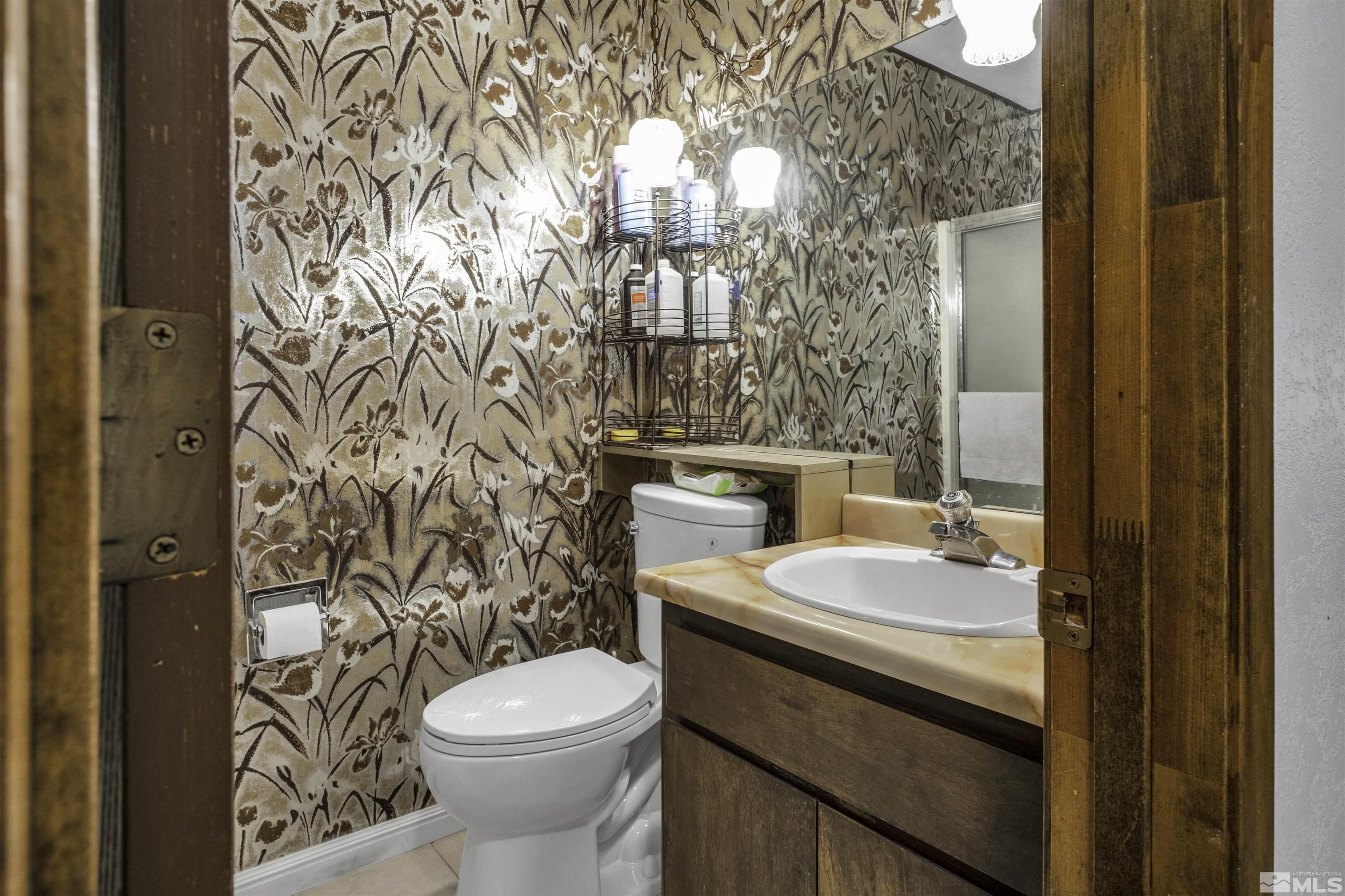 174 Juniper Drive Stateline, NV 89449 - Photo 20 of 32 a bathroom with a granite countertop toilet and a sink