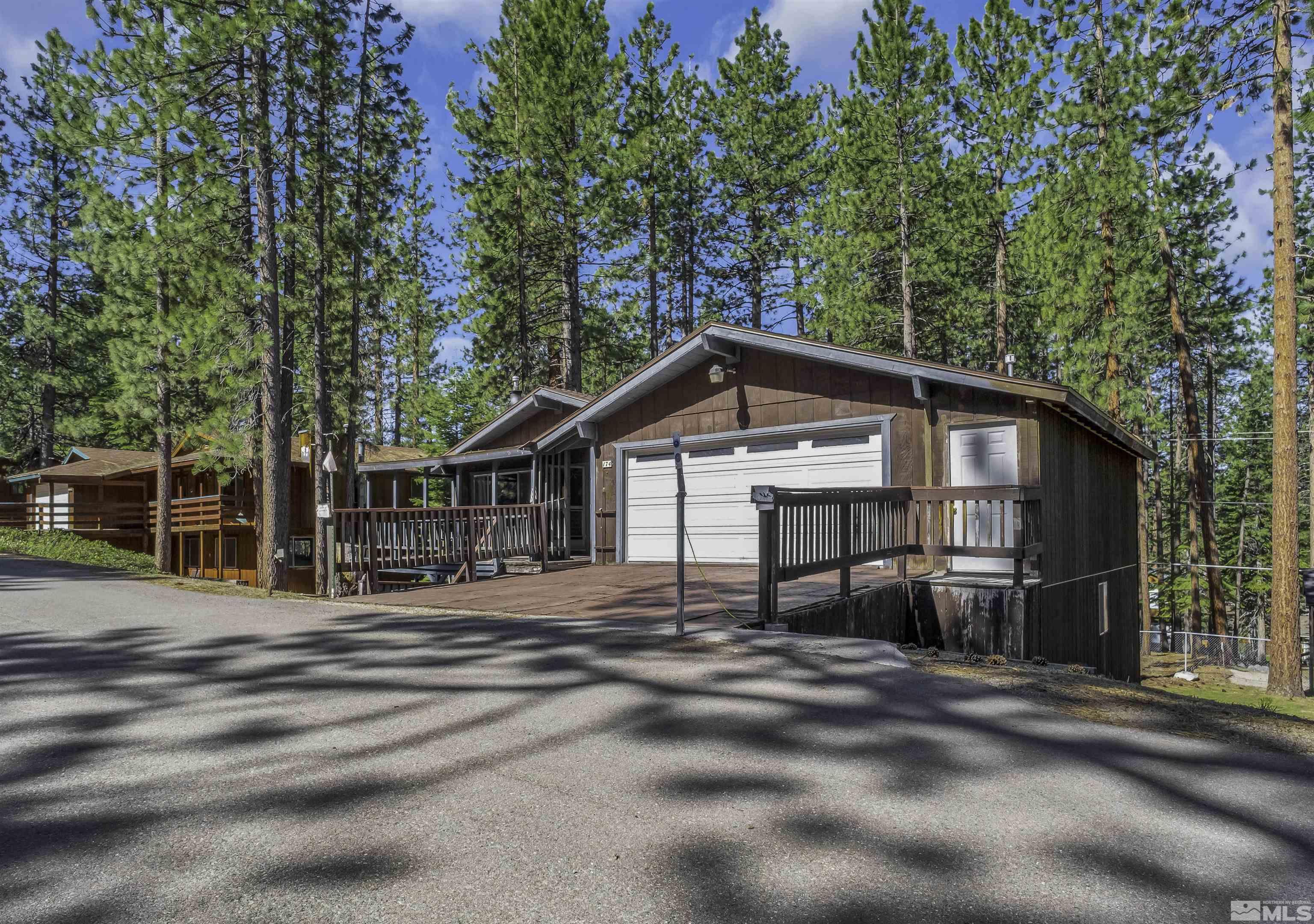 174 Juniper Drive Stateline, NV 89449 - Photo 2 of 32 a view of a house with a big yard and large trees