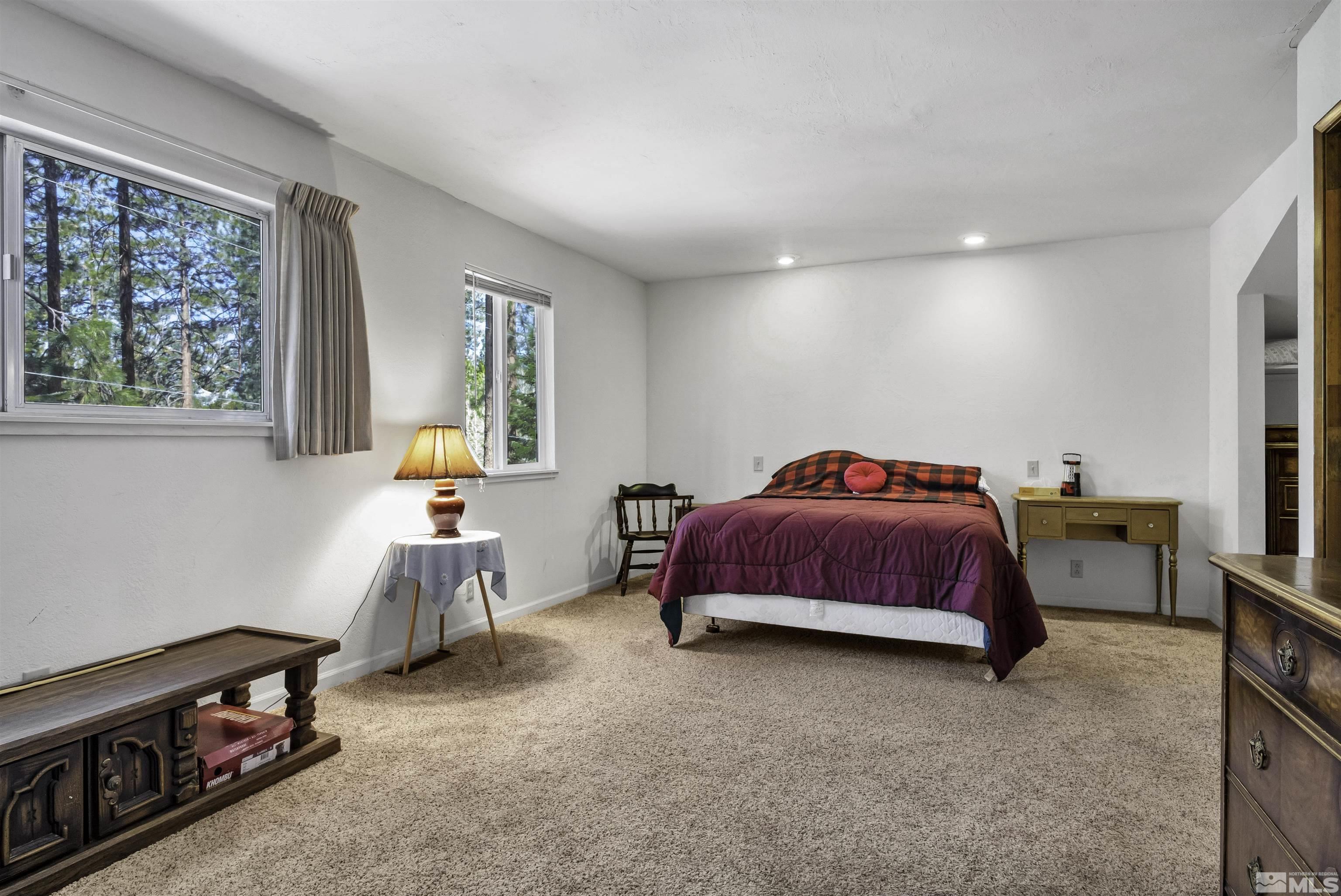 174 Juniper Drive Stateline, NV 89449 - Photo 21 of 32 a bedroom with a bed and a window