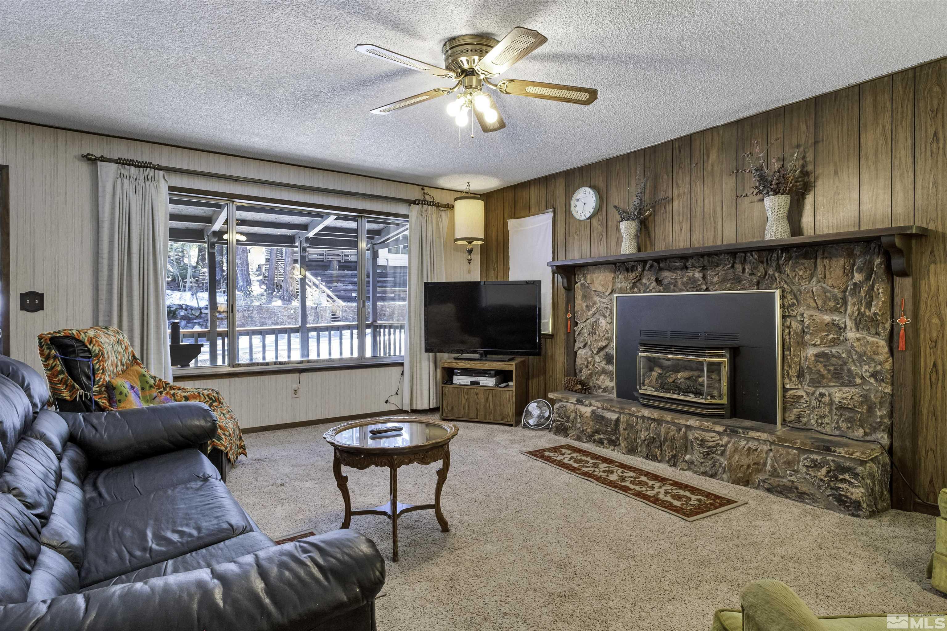 174 Juniper Drive Stateline, NV 89449 - Photo 6 of 32 a living room with furniture a flat screen tv and a fireplace