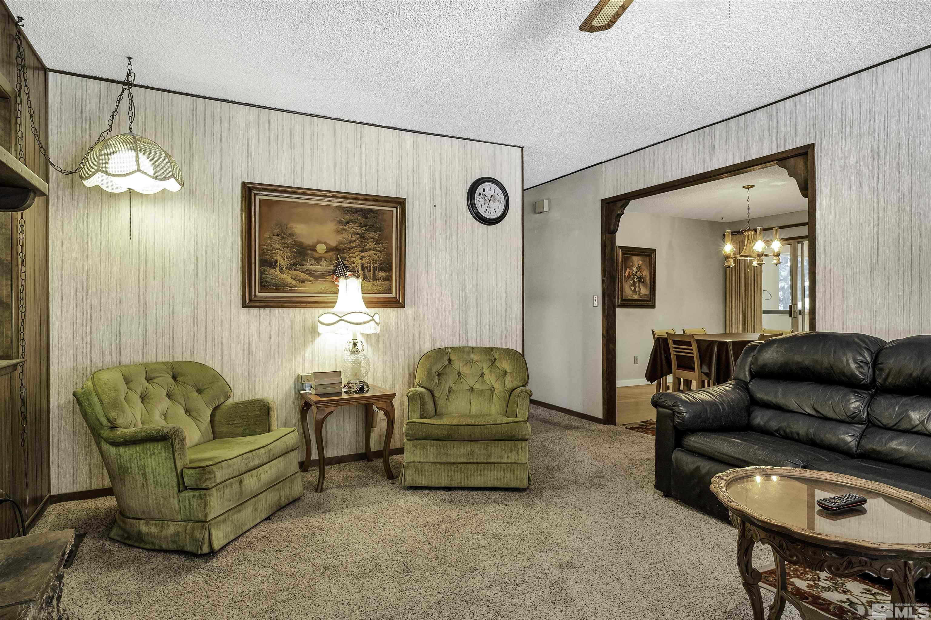174 Juniper Drive Stateline, NV 89449 - Photo 9 of 32 a living room with furniture and a chandelier