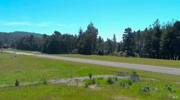 a view of a green field with clear sky