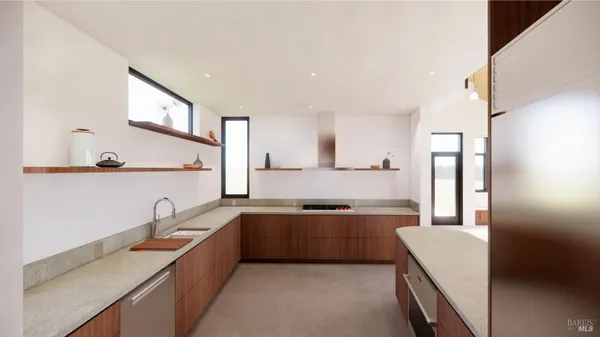 a large kitchen with stainless steel appliances a sink and a refrigerator