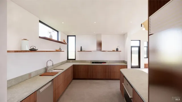 a large kitchen with stainless steel appliances a sink and a refrigerator