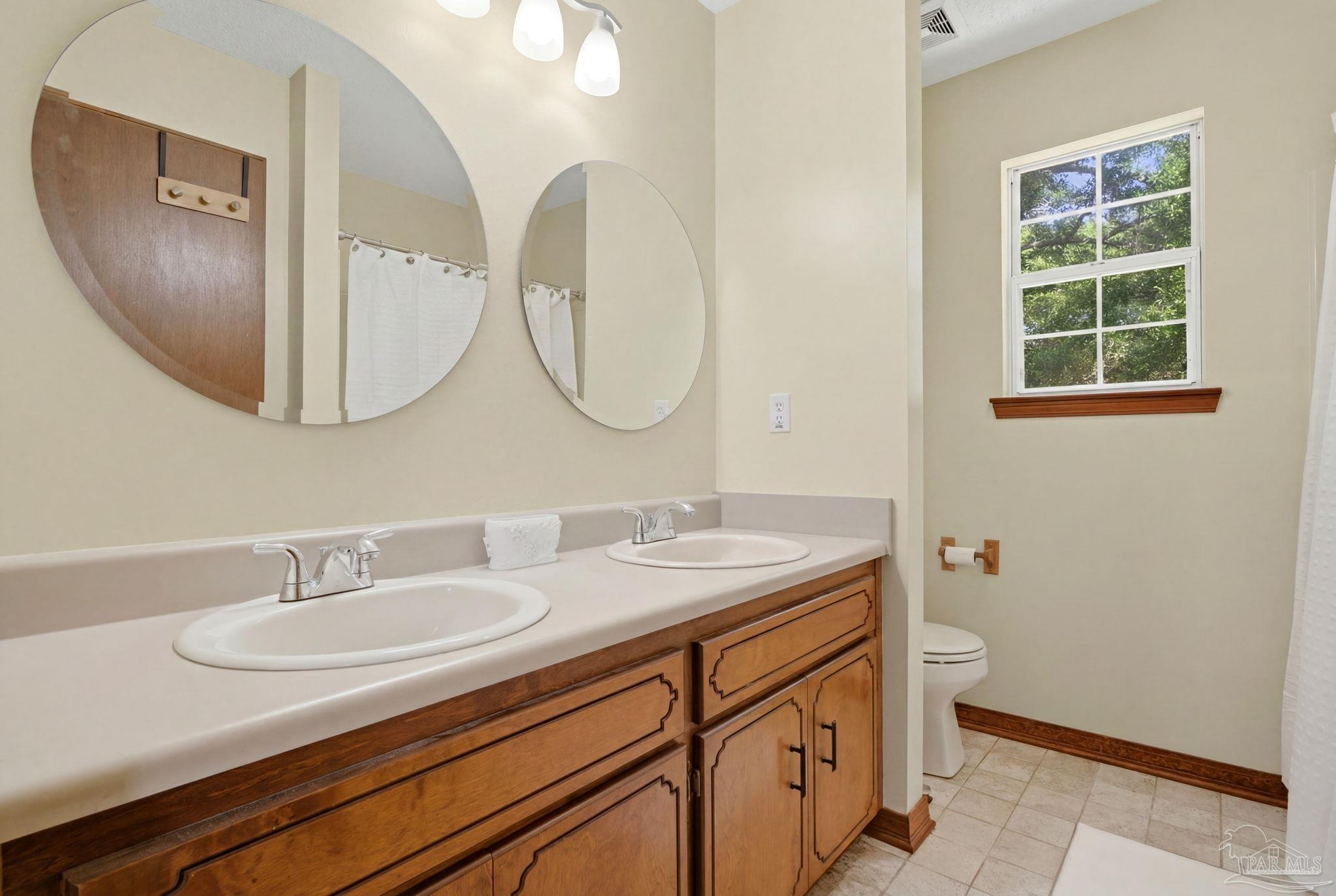 6870 Martin Road Milton, FL 32570 - Photo 33 of 48 a bathroom with a sink and a mirror