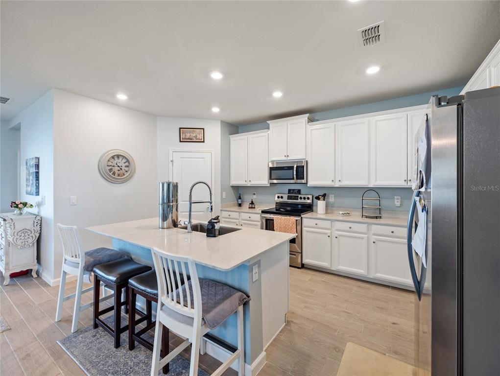 7580 Southwest 78th Terrace Ocala, FL 34481 - Photo 11 of 48 a kitchen with kitchen island a appliances dining table and chairs