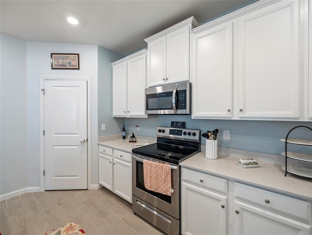 7580 Southwest 78th Terrace Ocala, FL 34481 - Photo 12 of 48 a kitchen with stainless steel appliances white cabinets and a sink