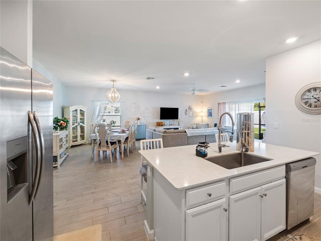 7580 Southwest 78th Terrace Ocala, FL 34481 - Photo 13 of 48 a kitchen with stainless steel appliances a sink a table and chairs