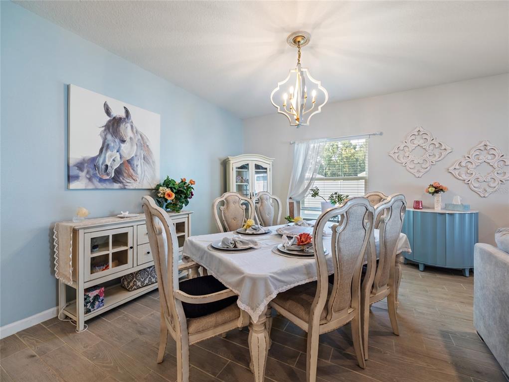 7580 Southwest 78th Terrace Ocala, FL 34481 - Photo 14 of 48 a view of a dining room with furniture window and wooden floor