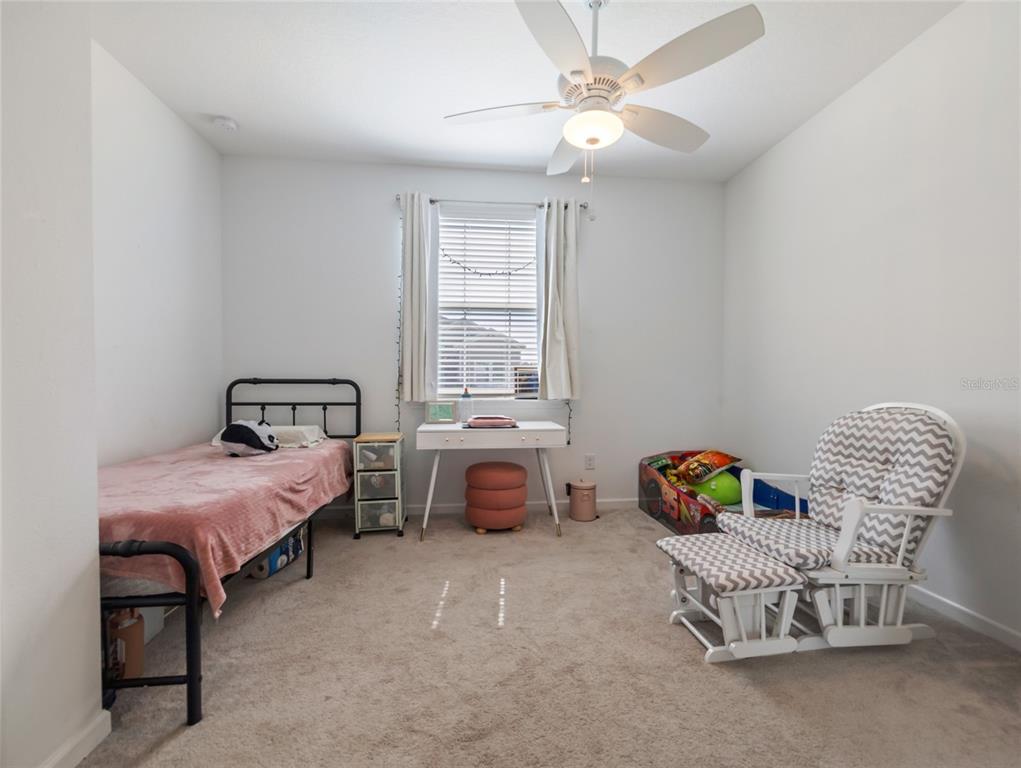7580 Southwest 78th Terrace Ocala, FL 34481 - Photo 17 of 48 a bedroom with a bed and a chandelier