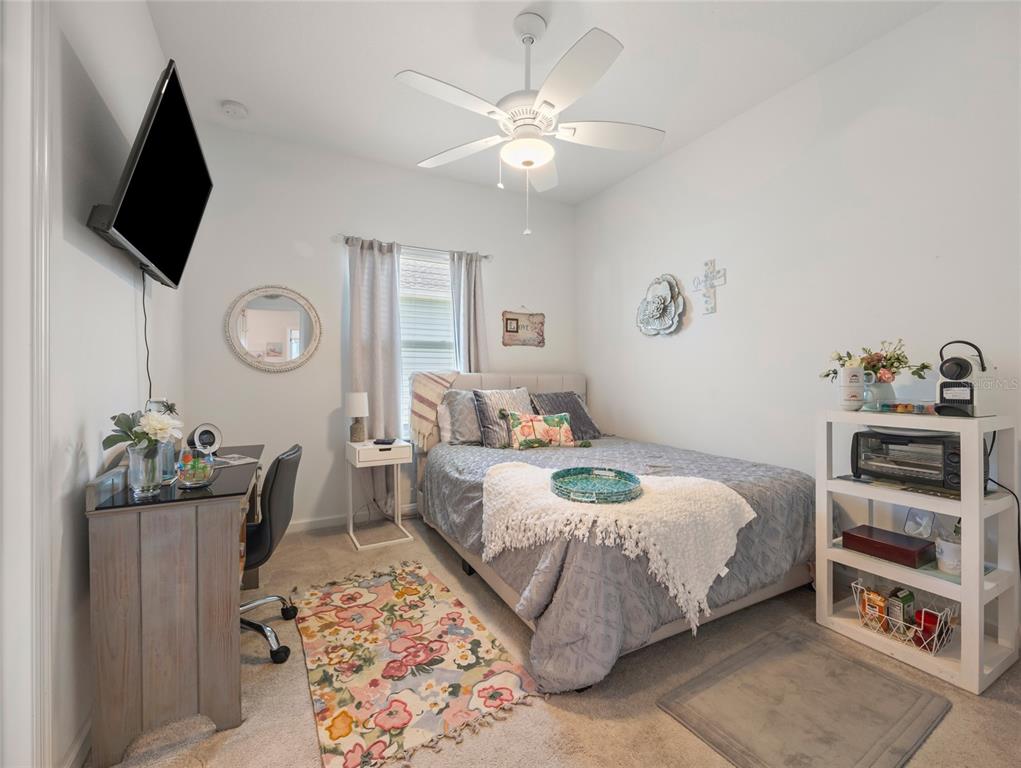 7580 Southwest 78th Terrace Ocala, FL 34481 - Photo 21 of 48 a bedroom with a bed and a television