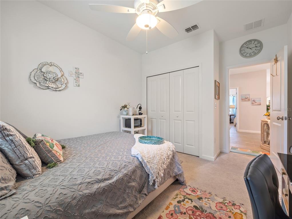 7580 Southwest 78th Terrace Ocala, FL 34481 - Photo 24 of 48 a bedroom with a bed and a chandelier