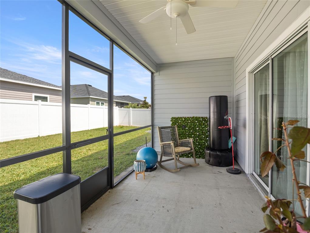 7580 Southwest 78th Terrace Ocala, FL 34481 - Photo 32 of 48 a view of a porch with furniture and floor to ceiling window