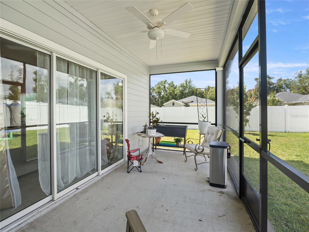 7580 Southwest 78th Terrace Ocala, FL 34481 - Photo 33 of 48 a living room with furniture and a floor to ceiling window