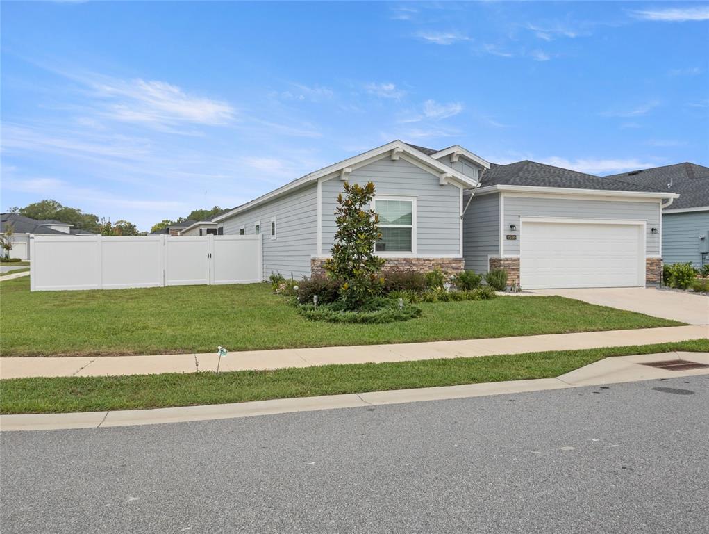 7580 Southwest 78th Terrace Ocala, FL 34481 - Photo 34 of 48 a front view of a house with a yard and garage