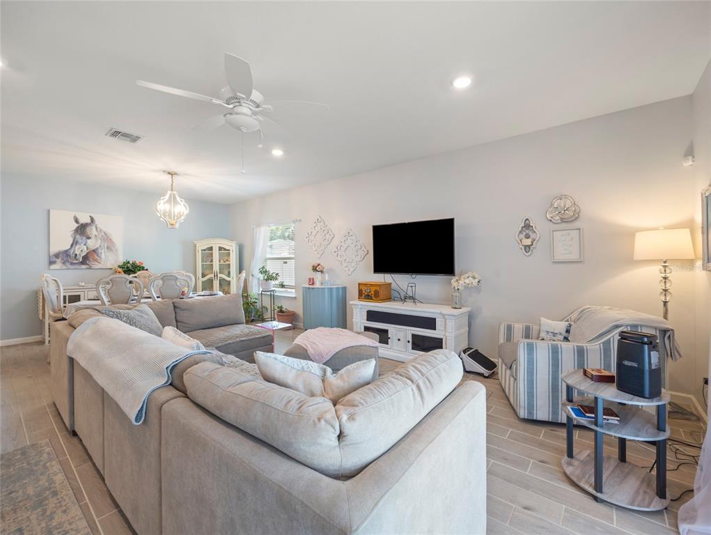 7580 Southwest 78th Terrace Ocala, FL 34481 - Photo 8 of 48 a living room with furniture and a flat screen tv