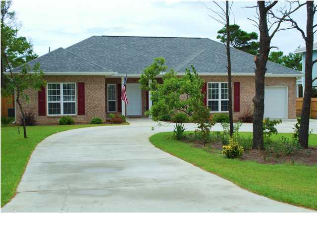 54 Maple Street Santa Rosa Beach, FL 32459 - Photo 1 of 9 a front view of a house with a yard and potted plants
