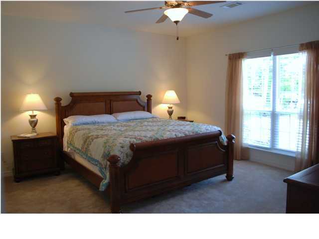 54 Maple Street Santa Rosa Beach, FL 32459 - Photo 4 of 9 a bedroom with a bed window and a chandelier