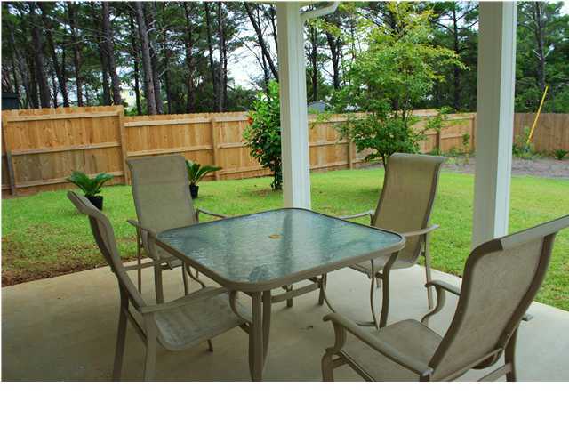 54 Maple Street Santa Rosa Beach, FL 32459 - Photo 8 of 9 a backyard of a house with table and chairs
