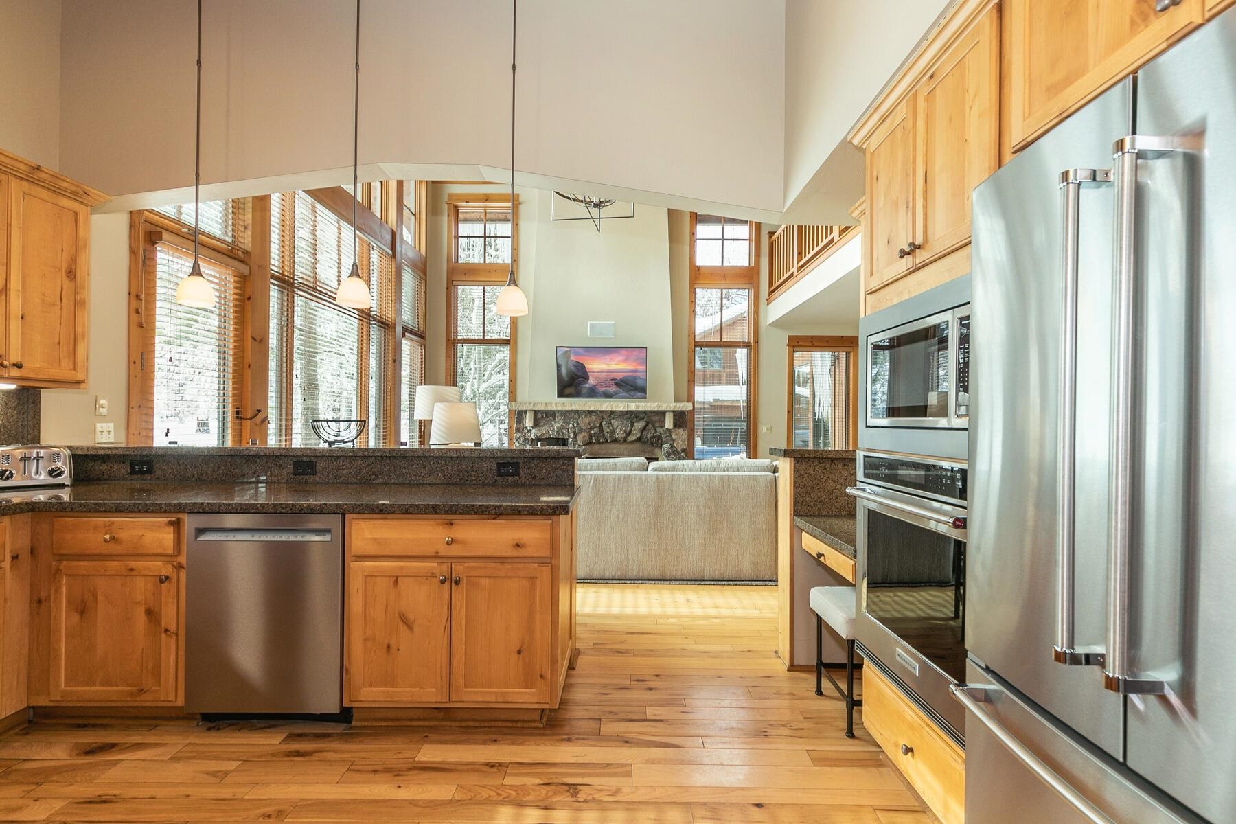 12247 Lookout Loop, Unit F603 Truckee, CA 96161 - Photo 12 of 28 a kitchen with stainless steel appliances granite countertop a refrigerator a stove and a sink with wooden floor