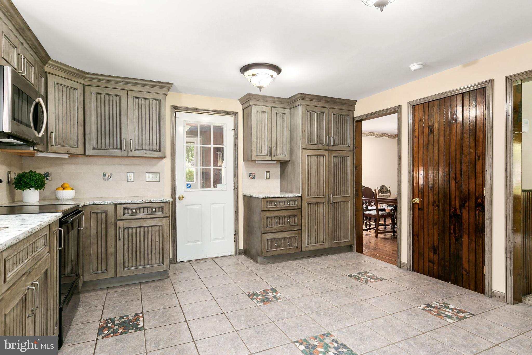 86 Hopkins Road New Egypt, NJ 08533 - Photo 6 of 37 a kitchen with stainless steel appliances granite countertop a refrigerator and a stove top oven