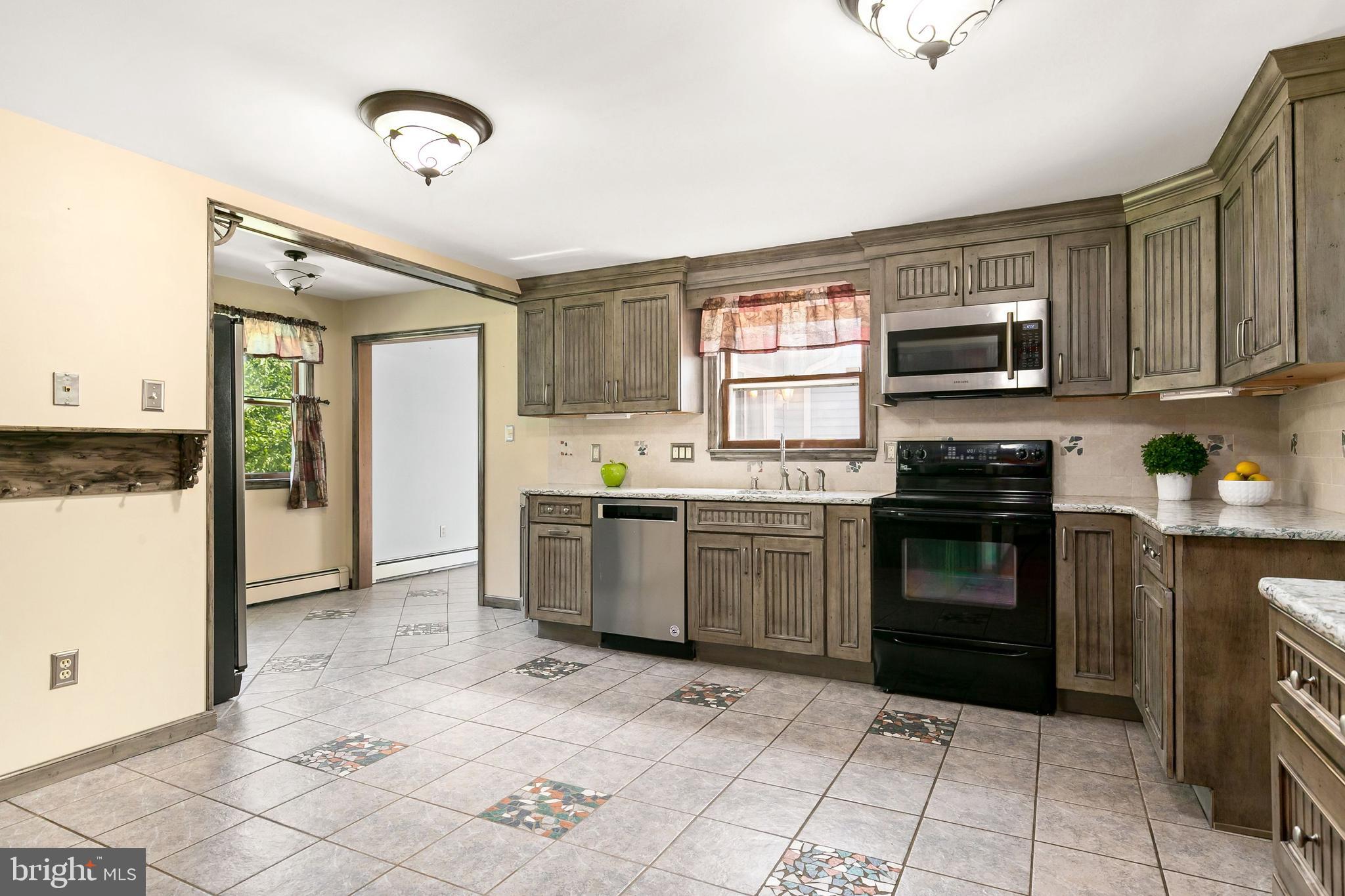 86 Hopkins Road New Egypt, NJ 08533 - Photo 7 of 37 a kitchen with granite countertop a stove a sink and a refrigerator